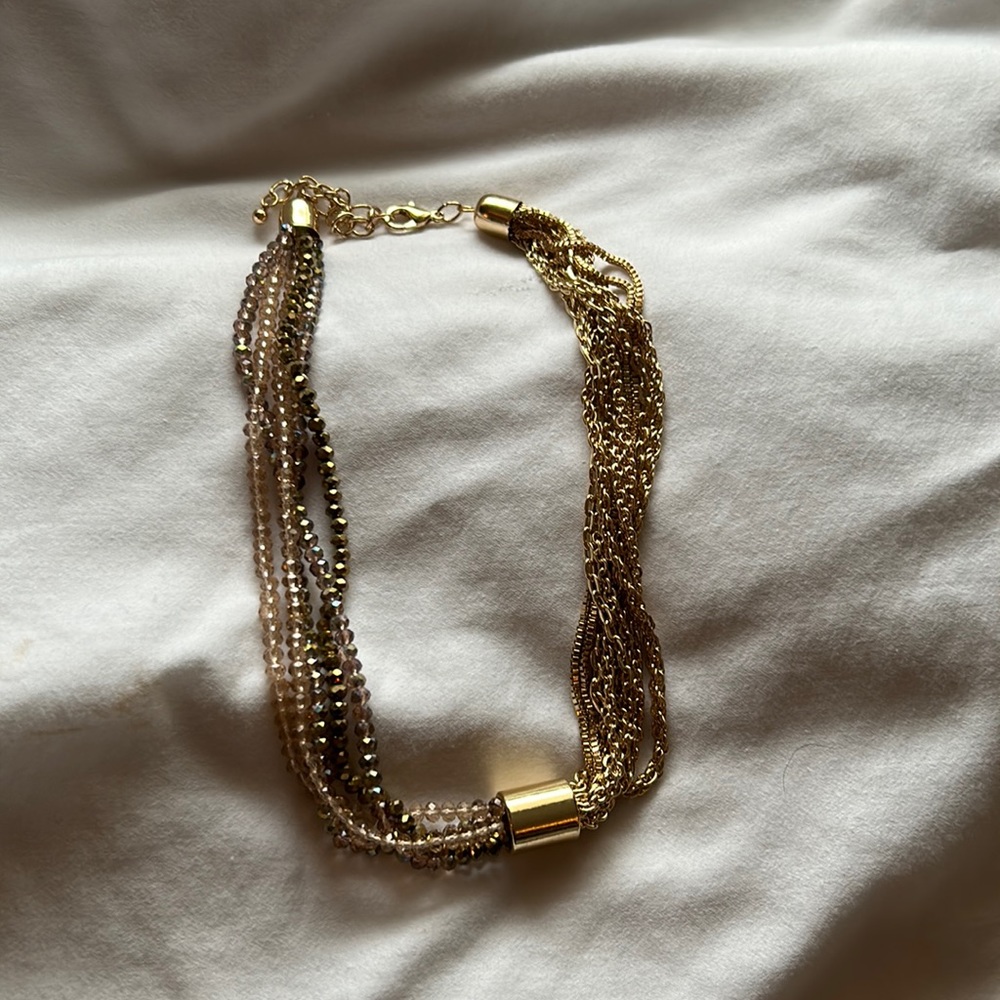 Necklace with adjustable lobster clasp. Multiple gold chains.